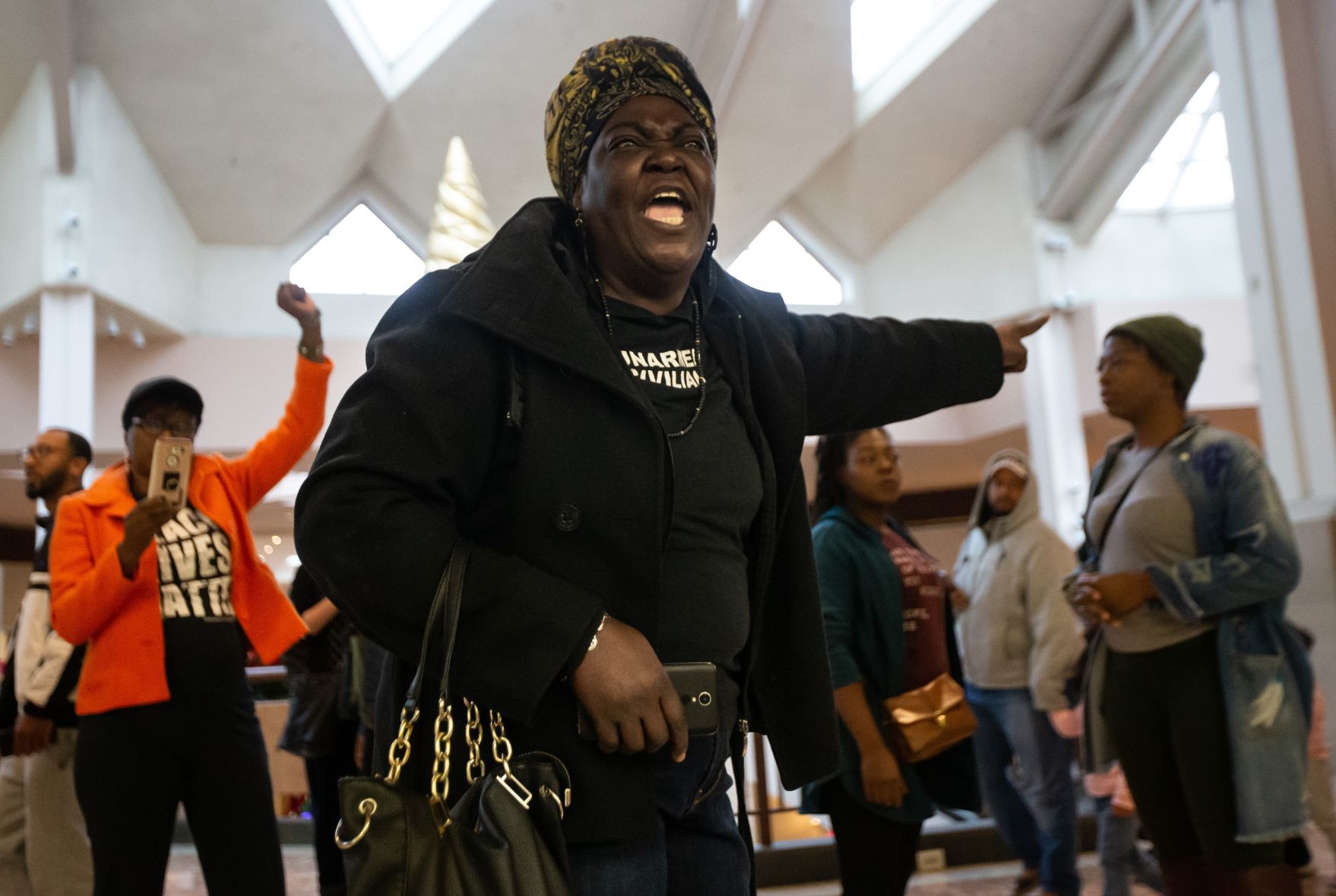 Protesters march in the St. Louis Galleria on Black Friday
